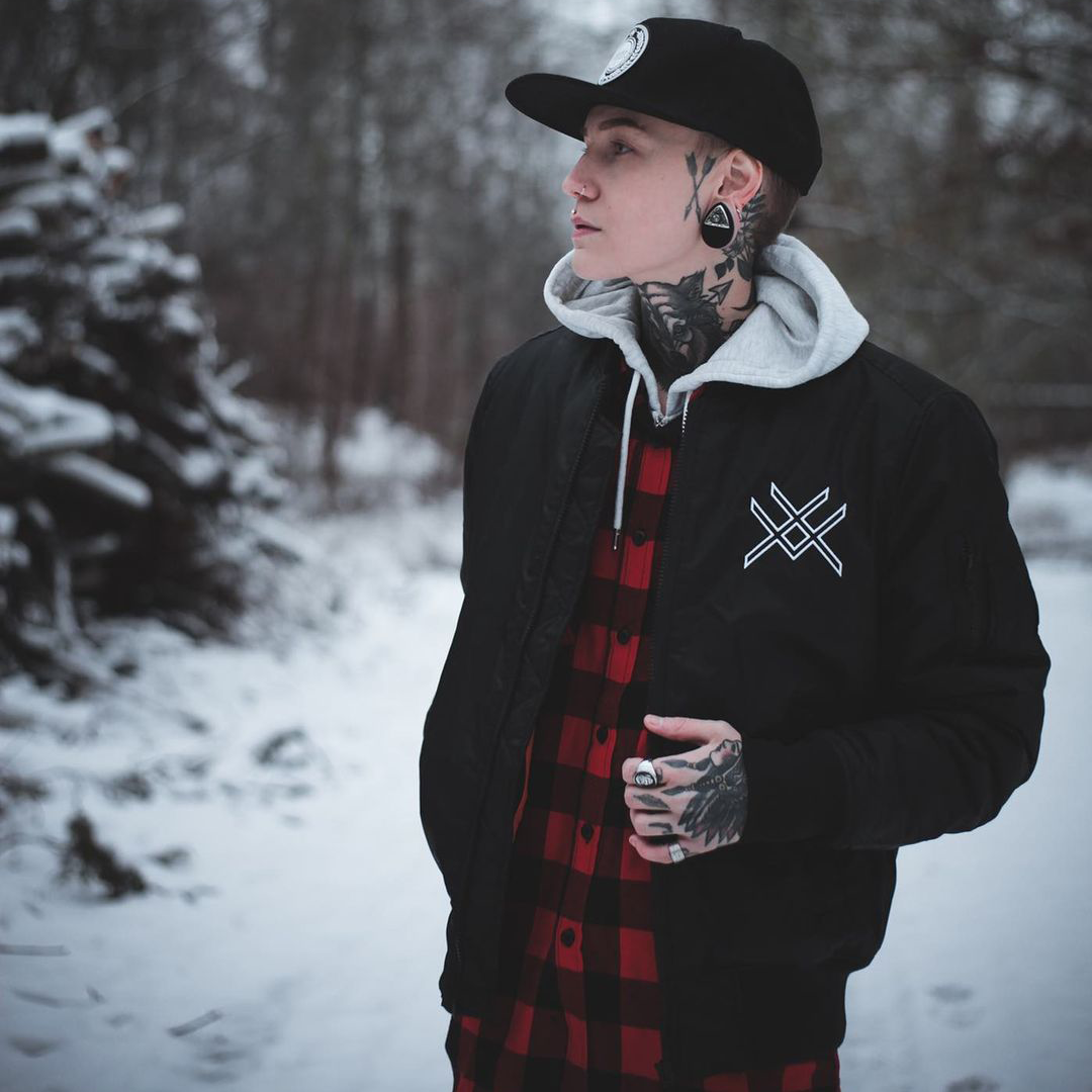 Girl in snow with bomber jacket and tattoos RIMFROST