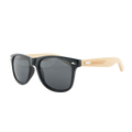 Sunglasses with black lenses and beige arms on a white background