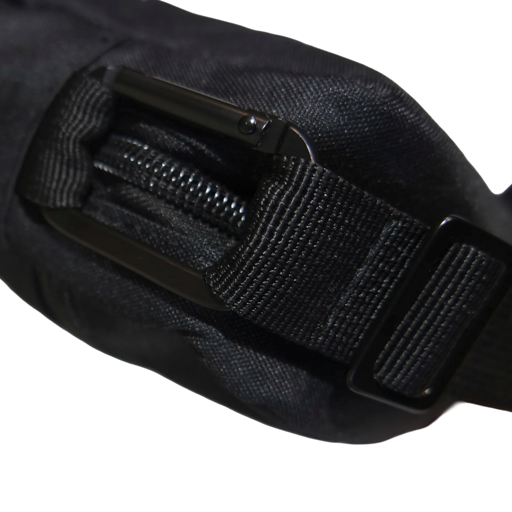 Close-up of a black belt with a buckle on a white background