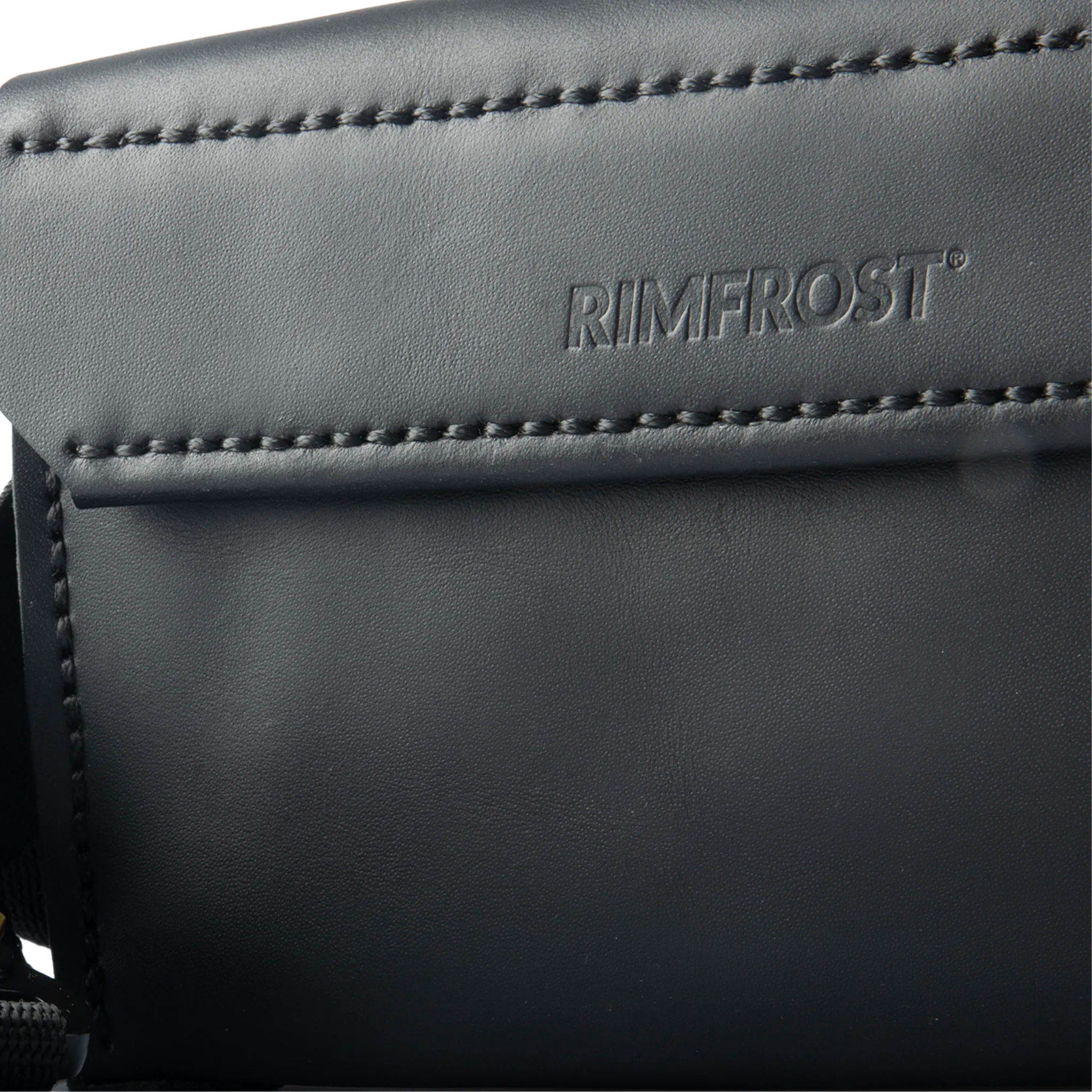 Close-up of a black leather product with 'RIMFROST' branding.